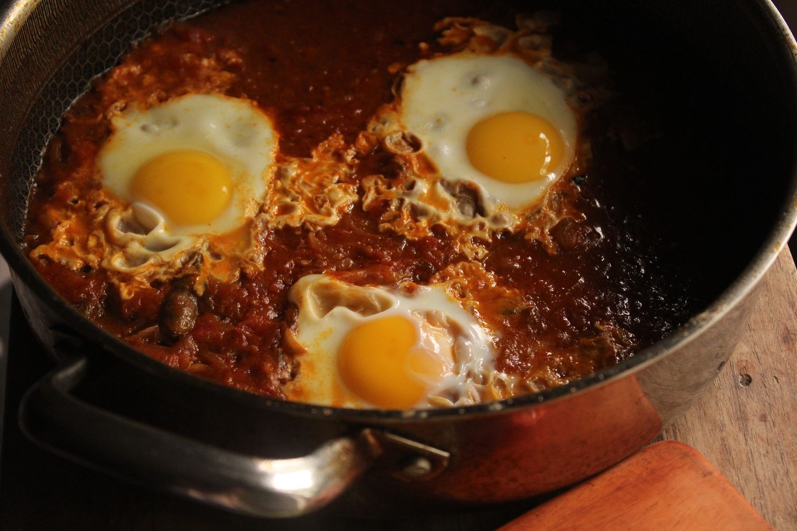 Eggs cooked in tomato sauce in a cast-iron skillet